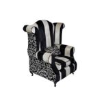 A large contemporary Mr McQueen wing back armchair, made by Richard James