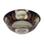 A large late 19th/early 20th century Continental porcelain bowl, decorated in the English taste,