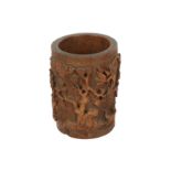 A relief carved A late 19th/early 20th century Chinese hardwood cylindrical brush pot