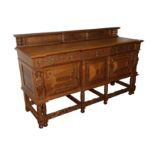 A early 20th century Renaissance Revival oak breakfront sideboard