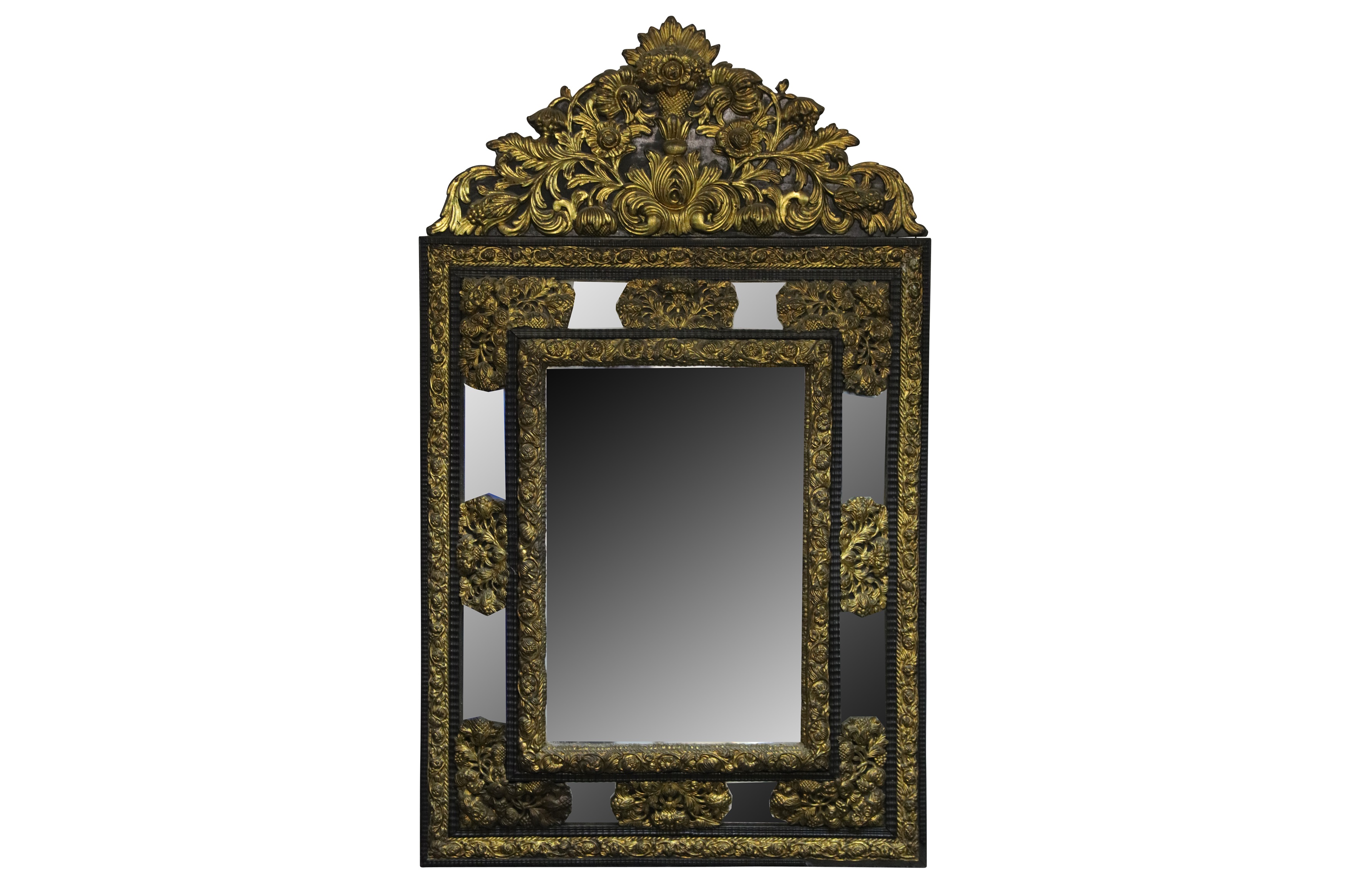 A late 19th century Flemish gilt and ebonised cushion framed mirror