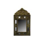 A late 19th century Flemish gilt and ebonised cushion framed mirror