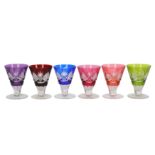 A set of six small clear and coloured glass wine glasses