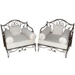 A pair of French wrought iron conservatory armchairs, in the manner of Les Lalanne