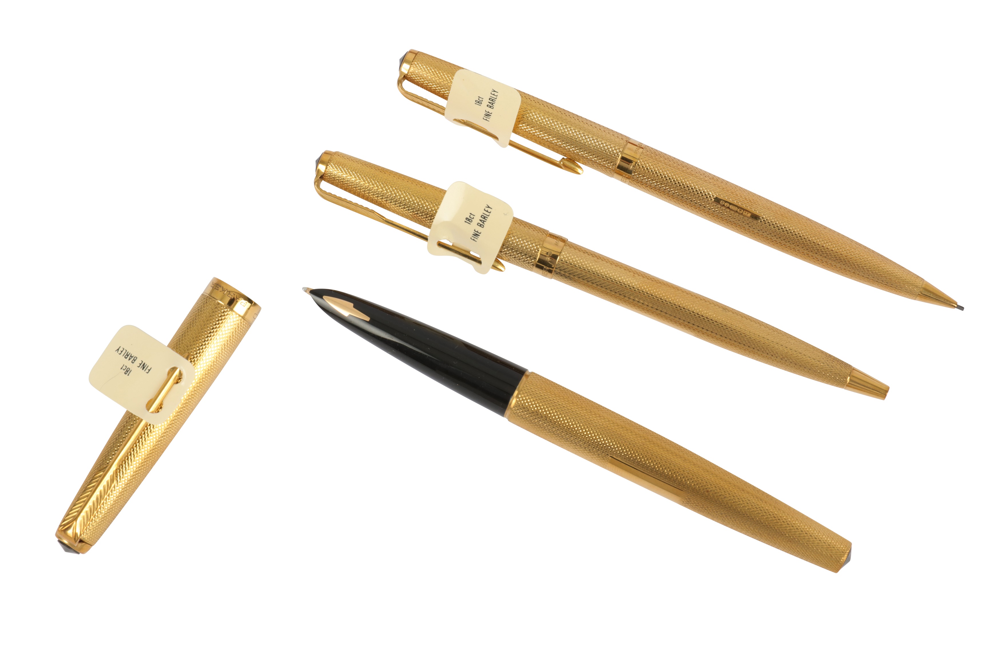 A set of three 18ct gold Parker pens,