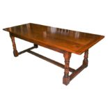 A 17th century style oak extending refectory dining table