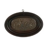 A 19th century French oval bronze plaque depicting five cherubs in the actions of priming their bows
