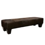 A contemporary cow hide upholstered stool