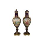 A pair of late 19th/early 20th century French Sevres style porcelain and gilt metal mounted vases
