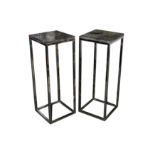 A pair of 'Fast Black' side tables with petrified wood tops