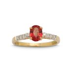 An orange sapphire and diamond ring