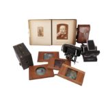 A Selection of Cameras, A Photograph Album, a Voigtlander Lens, and Magic Lanterns slides