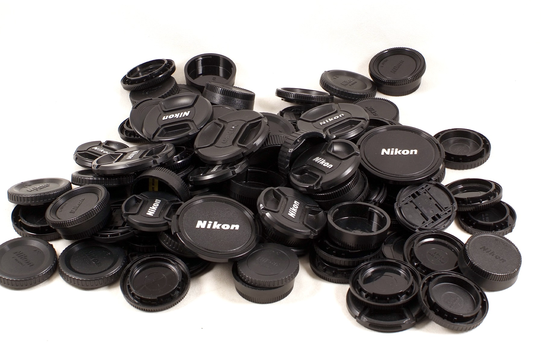 Around 80 Nikon Camera Body Caps & Lens Caps