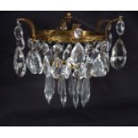 A pendant ceiling lustre, the two circular tiers hung with prismatic drops,