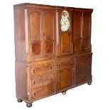 A George III oak housekeeper's cupboard incorporating an eight-day clock with moon phase, signed W.