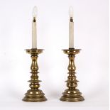 A pair of European brass pricket candlesticks, with ringed baluster stems and domed bases,