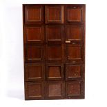 An Edwardian mahogany bank of lockers, fifteen hinged compartments,