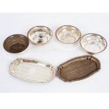 A pair of silver pin trays, Birmingham 1926, shaped oval, 13cm wide and four circular ashtrays,