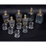 A set of four decanters and stoppers with gilt collars, marked Daum Nancy, in two sizes,