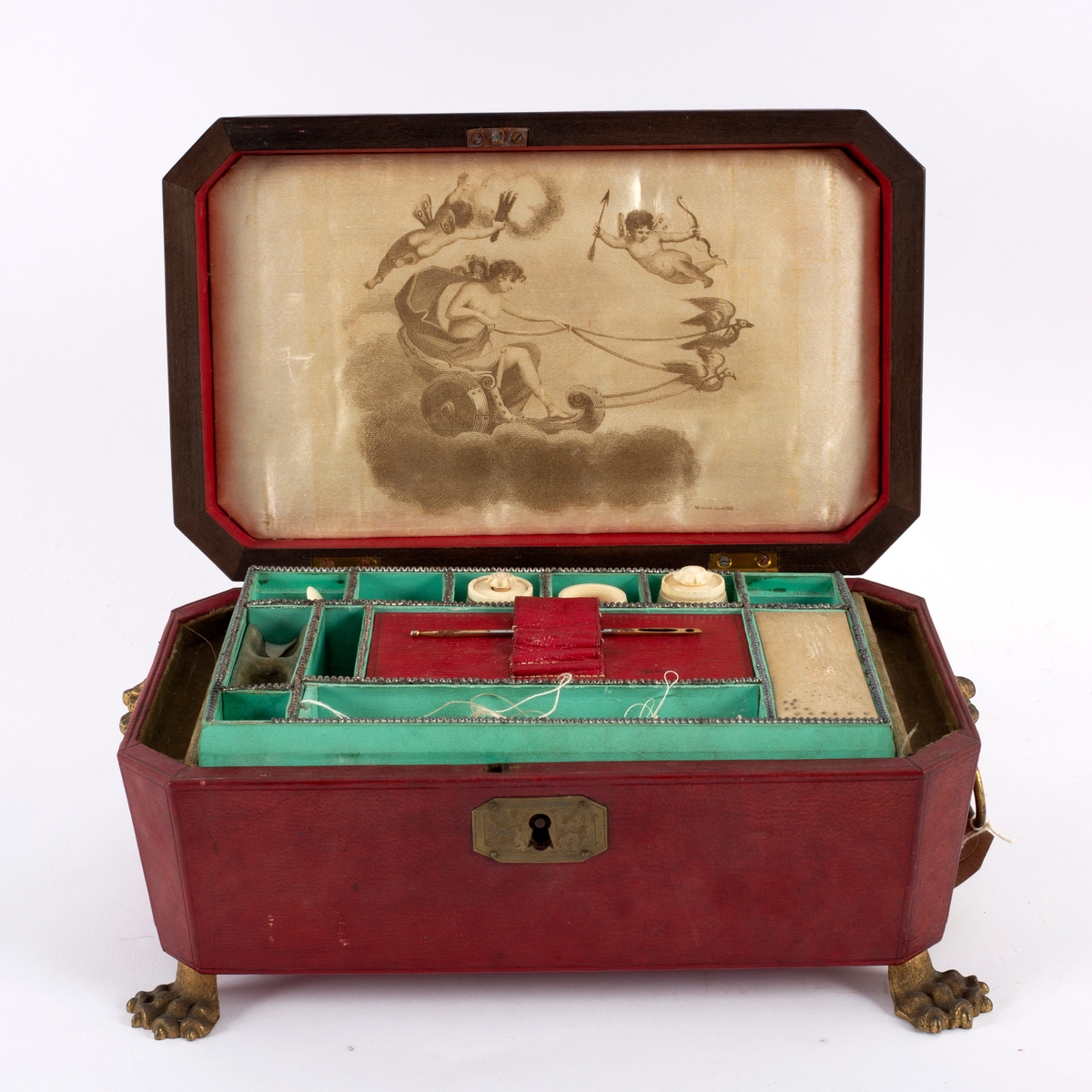 A Regency leather covered sewing box with brass lion mask ring handles and paw feet,