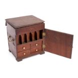 An early 19th Century mahogany apothecary's box, the lift lid concealing compartments,