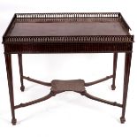 A mahogany silver table, in George III style, the fretted oblong gallery over a fluted frieze,
