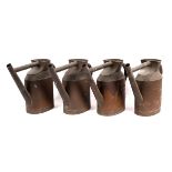 Four copper watering cans,