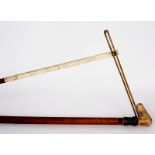 An Edwardian walking stick with spirit level and scaled ruler,