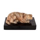 A carved alabaster figure of a recumbent dog, 19th Century English, the plinth 8.