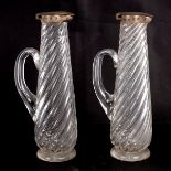 A pair of Victorian silver mounted ewers, Birmingham 1891, of spirally fluted form, crested,