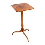 A George III satinwood table, circa 1805, the oblong top on a turned tapering stem and ogee tripod,