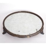 A Sheffield plate circular mirror plateau, circa 1820, on claw feet,