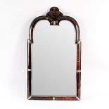 An early 18th Century and later tortoiseshell and silver mounted mirror of arched shape with