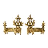 A pair of gilt metal chenets, of neo-classical design,