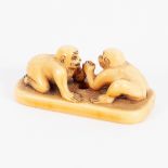 A Japanese ivory netsuke, 18th Century, in the form of two monkeys arm wrestling, 4.