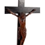 A carved boxwood crucifixion, the figure of Christ to an oak cross, on a stepped plinth,