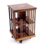 An Edwardian mahogany revolving bookstand, banded with satinwood and strung with box and ebony,
