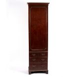 A narrow George III style mahogany hanging cupboard, the panel door with dummy drawers,