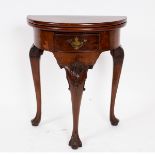 A walnut semi-circular fold-over top tea table, in George I style,