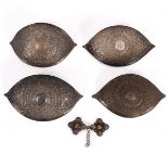 Four Eastern white metal buckles of pointed oval shape,