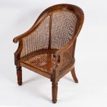 A William IV rosewood bergère, circa 1835, with scrolled arms,