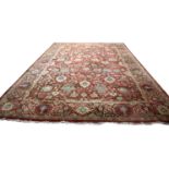 A modern Agra carpet, with palmettes, flowers and scrolling foliage to a wine red field,