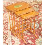 A nest of three satinwood tables, with painted decoration of cherubs and swags,