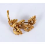 An 18ct gold and diamond leaf spray brooch, BRLd, set with six small diamonds, 4.
