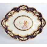 A Derby lobed oval dish, circa 1800, painted to the centre with a cherub and hounds hunting a stag,