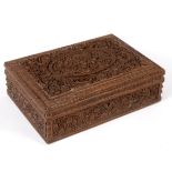 An Indian carved sandalwood/cedar wood box, the cover with profusely carved foliate decoration,