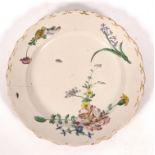 A Marseille faience plate, Gaspar Robert's factory, circa 1780, painted flowers and insects,