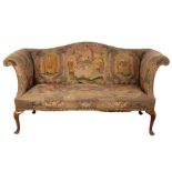 An 18th Century settee with needlework upholstery, on carved walnut cabriole legs,
