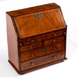 A miniature 18th Century style walnut and inlaid bureau, possibly a 19th Century apprentice piece,