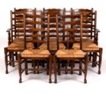 Eight elm ladder back chairs with rush seats on turned legs (six singles,